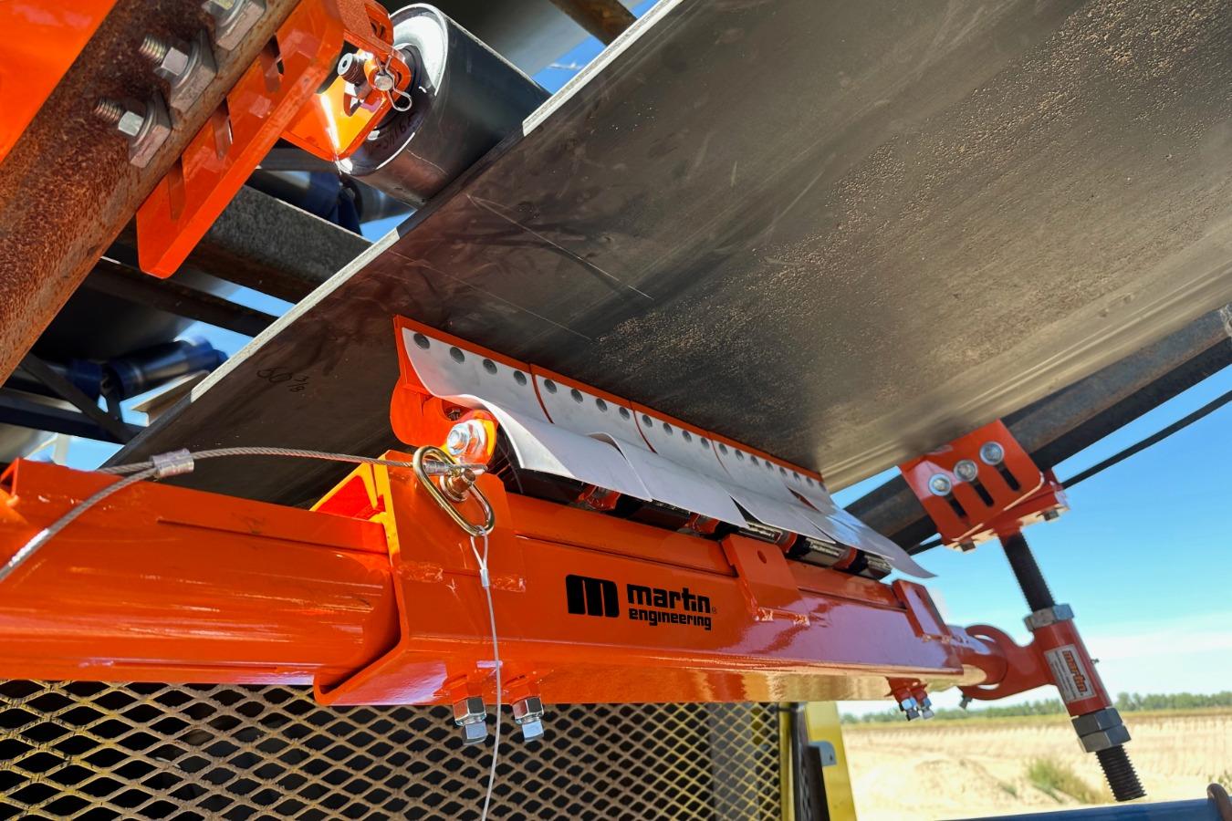Belt cleaner positioning on high volume conveyors